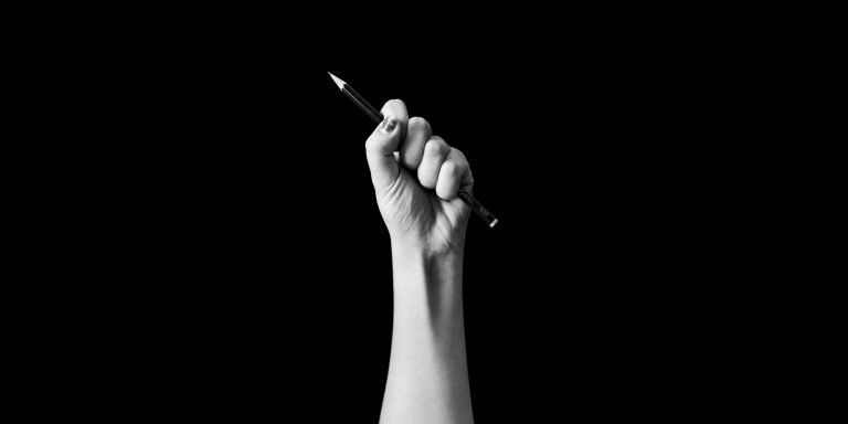 Hand holding pencil